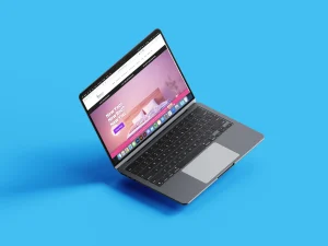 A laptop on a blue background displaying a colorful interior design website on its screen.